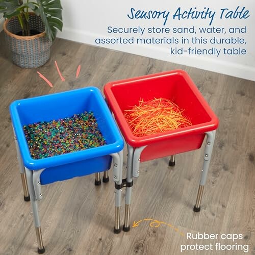 Sensory activity table with blue and red bins filled with beads and shredded paper.